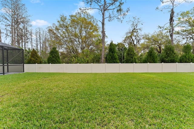 view of yard with glass enclosure