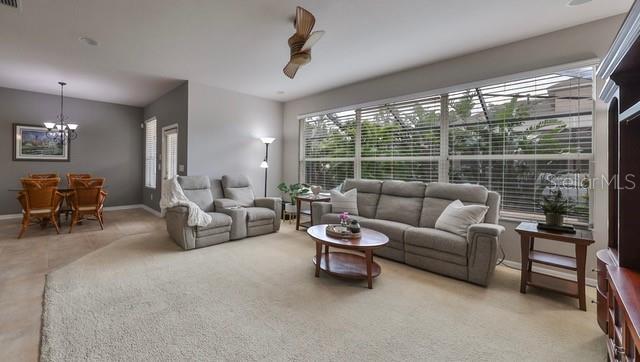 living room with carpet floors and a notable chandelier