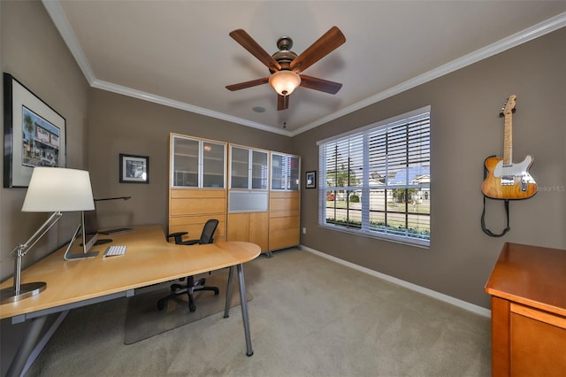 home office with ceiling fan, light colored carpet, and ornamental molding