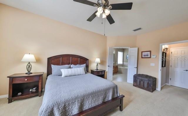 carpeted bedroom featuring connected bathroom and ceiling fan