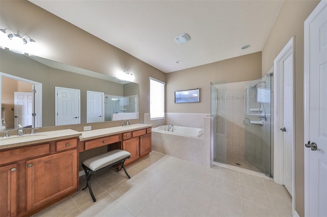 bathroom with tile patterned floors, vanity, and plus walk in shower