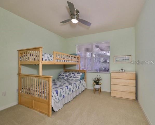 bedroom with ceiling fan and light colored carpet