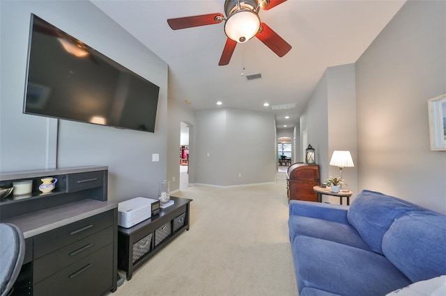 living room with ceiling fan and light colored carpet