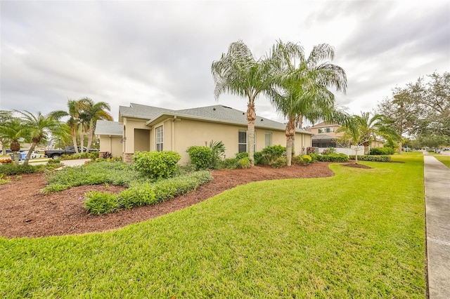 view of side of home with a lawn