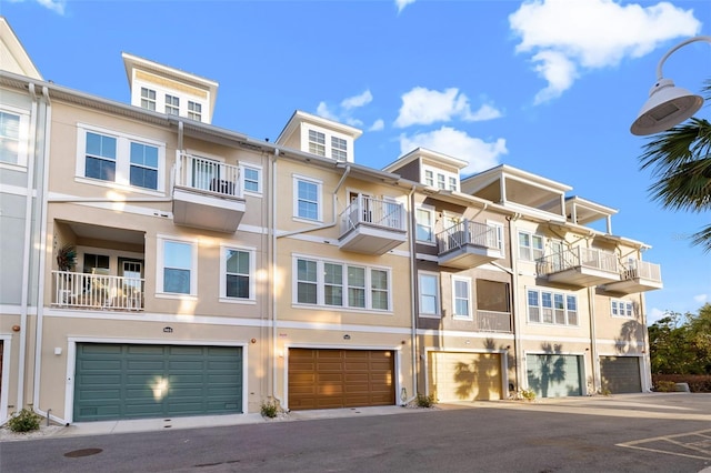 19915 Gulf Blvd Unit 805, Indian Shores, FL 33785 - view of front of home featuring stucco siding, an attached garage, and driveway