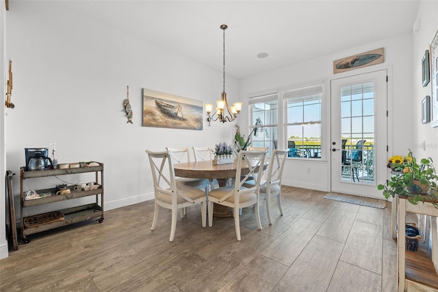 dining area with a chandelier and hardwood / wood-style flooring