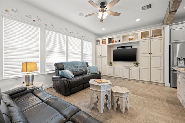 living room featuring ceiling fan and light hardwood / wood-style floors