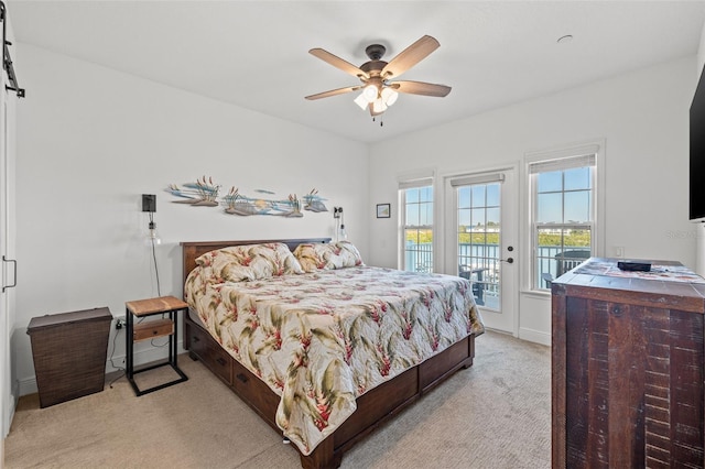 carpeted bedroom with ceiling fan and access to outside