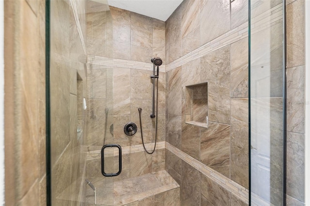 bathroom featuring a shower with door