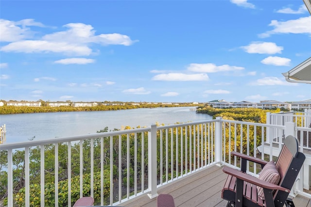 wooden terrace featuring a water view