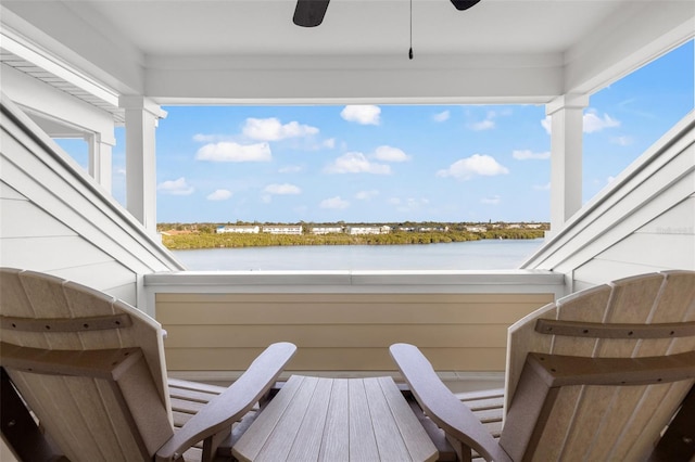 balcony featuring ceiling fan and a water view