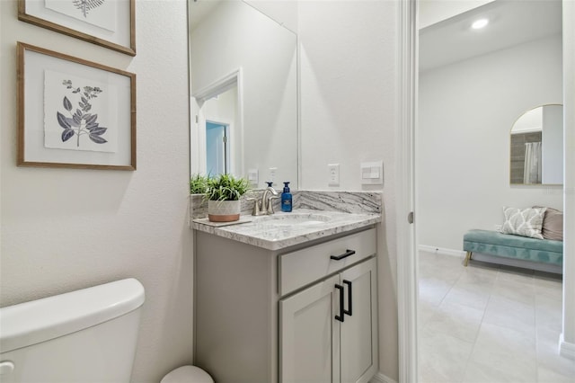 bathroom featuring tile patterned floors, vanity, and toilet