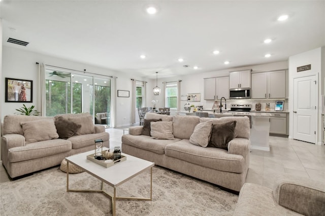 living room featuring light tile patterned floors and sink