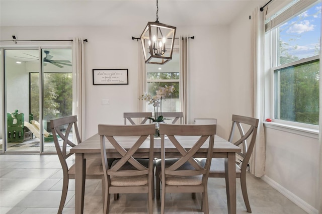 dining room with light tile patterned floors and a notable chandelier