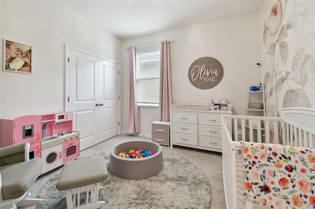 carpeted bedroom with a nursery area