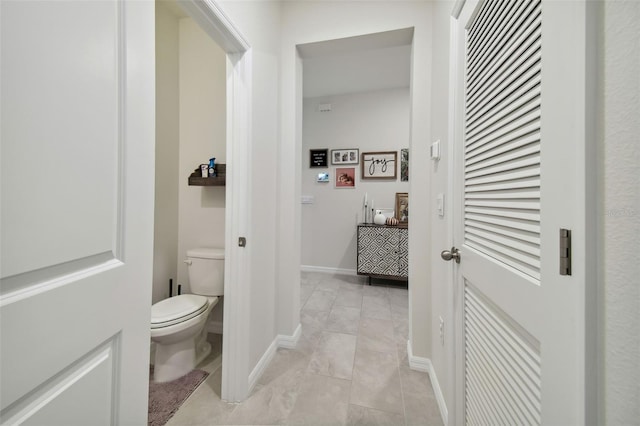 bathroom with tile patterned floors and toilet