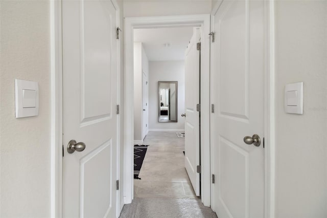 hallway featuring light tile patterned floors