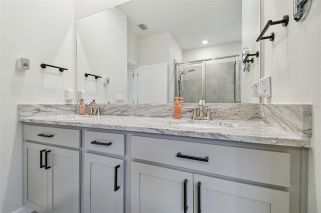 bathroom featuring vanity and an enclosed shower