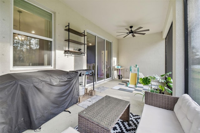 sunroom with ceiling fan with notable chandelier