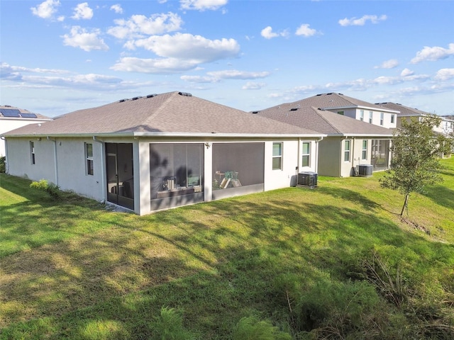 back of property featuring a yard, central AC unit, and a sunroom