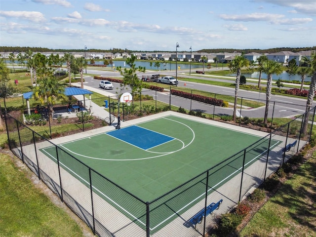 view of sport court with a water view