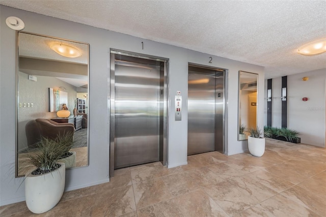 kitchen featuring a textured ceiling and elevator