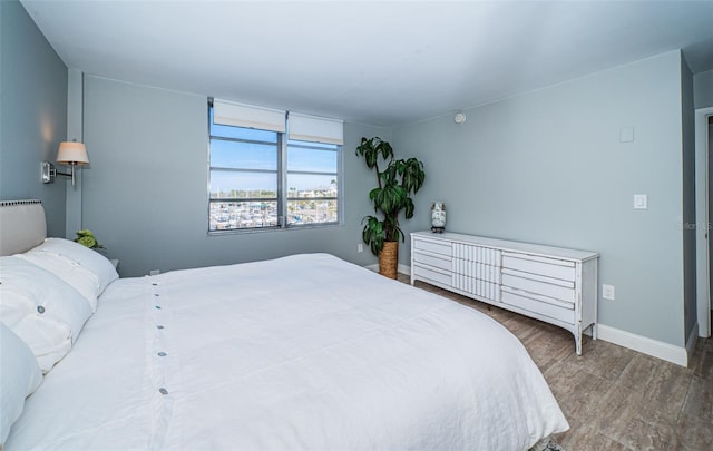 bedroom with hardwood / wood-style flooring