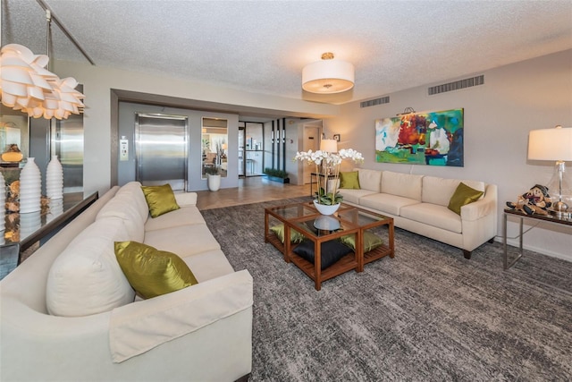 carpeted living room featuring a textured ceiling