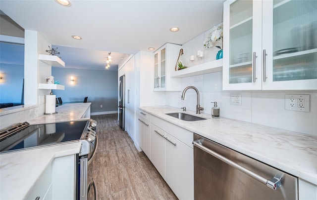 kitchen with sink, white cabinets, and stainless steel appliances