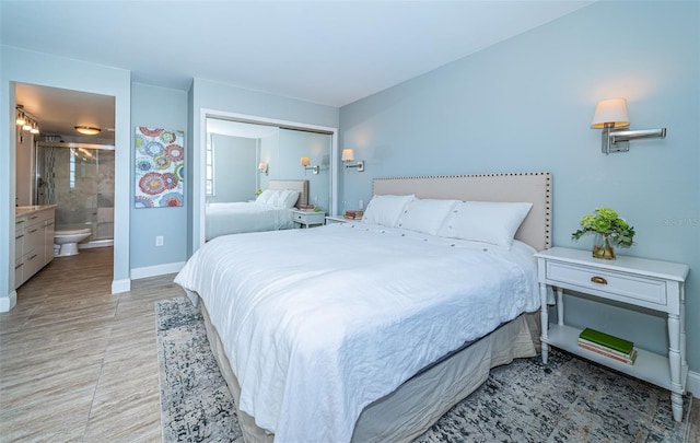 bedroom with ensuite bathroom and a closet