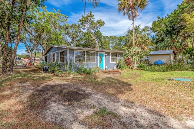 ranch-style home with an outbuilding