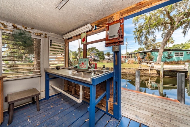 dock area featuring exterior bar and a water view