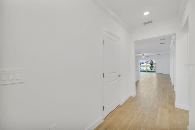 hallway featuring light hardwood / wood-style floors and ornamental molding