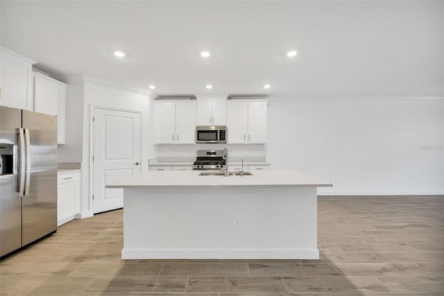 kitchen featuring white cabinets, sink, a kitchen island with sink, and appliances with stainless steel finishes