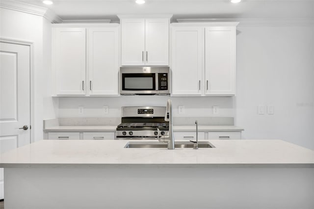 kitchen with crown molding, sink, white cabinetry, and stainless steel appliances