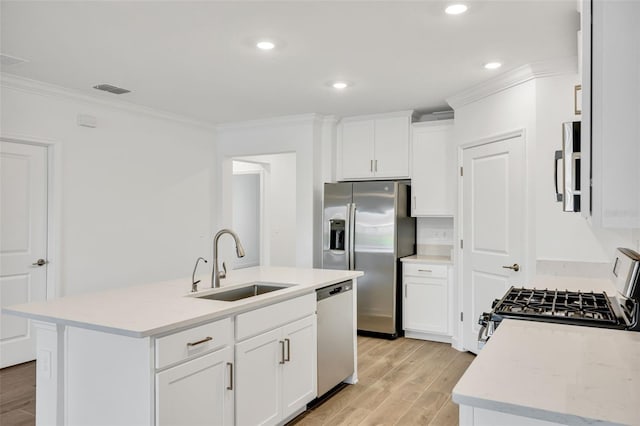 kitchen featuring white cabinets, sink, an island with sink, and stainless steel appliances