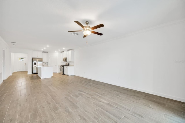 unfurnished living room featuring crown molding and ceiling fan