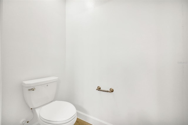 bathroom featuring hardwood / wood-style floors and toilet