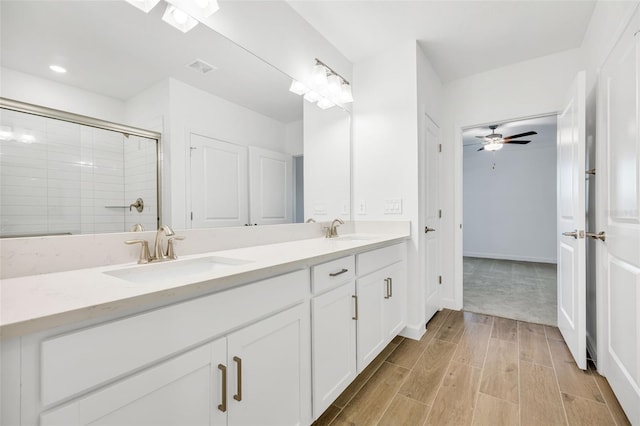 bathroom with ceiling fan, walk in shower, and vanity