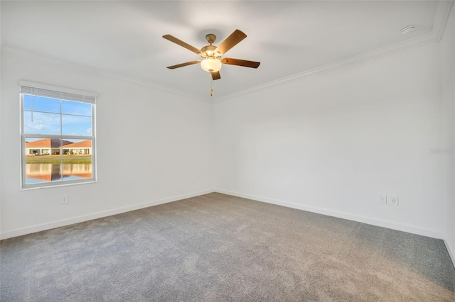 empty room with carpet flooring, ceiling fan, and ornamental molding