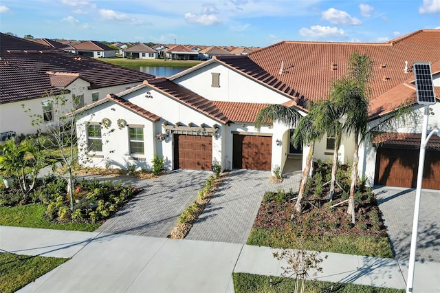 mediterranean / spanish home with a garage