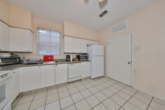 kitchen featuring white cabinets, light tile patterned floors, white appliances, and sink