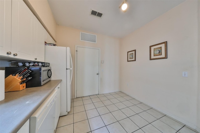 kitchen featuring white cabinetry, light tile patterned floors, and white appliances