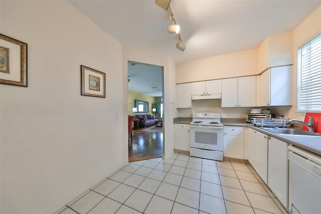 kitchen featuring white cabinetry, sink, white appliances, and light wood-type flooring