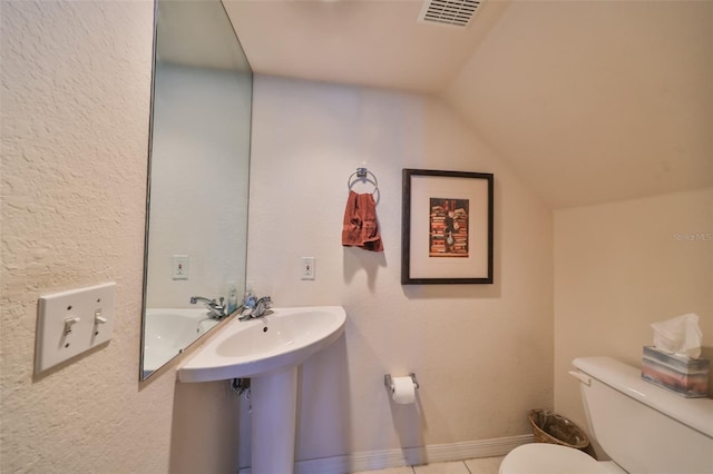 bathroom featuring toilet and vaulted ceiling