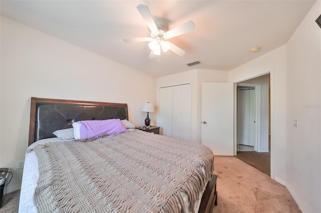 bedroom featuring light carpet, a closet, and ceiling fan