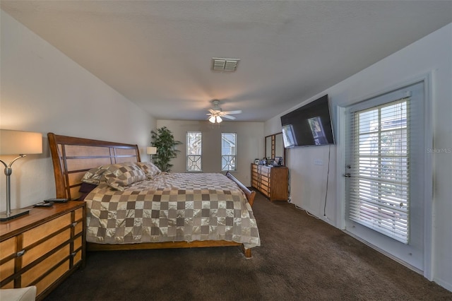 bedroom featuring dark colored carpet, ceiling fan, and access to exterior