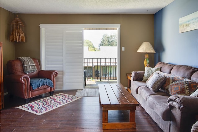 living room featuring a textured ceiling and dark hardwood / wood-style flooring