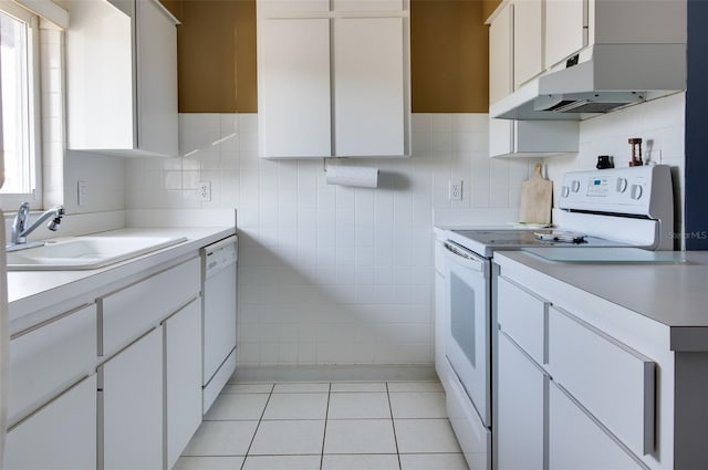 kitchen with sink, light tile patterned floors, white appliances, decorative backsplash, and white cabinets