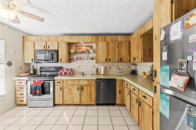 kitchen with backsplash, black appliances, sink, light tile patterned floors, and a textured ceiling